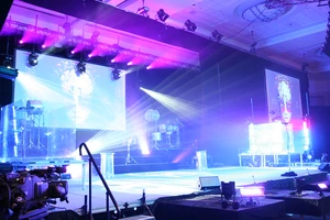 Stage with vibrant purple and blue lights.