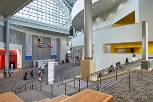 A spacious convention center lobby with banners.