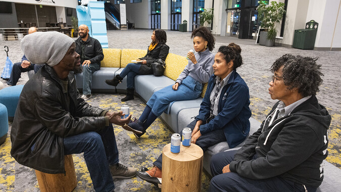 People of Color seated casually in conversation.