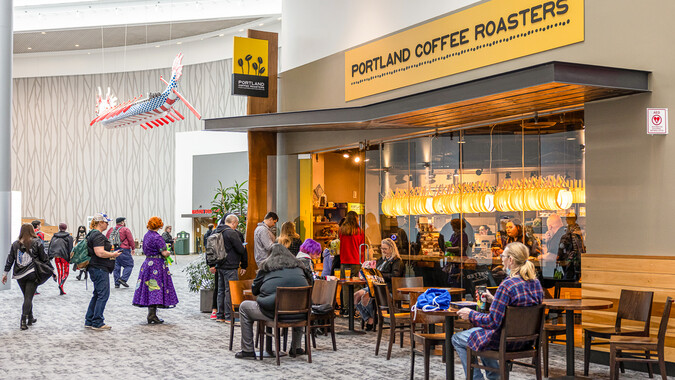 A coffee shop entrance with people.
