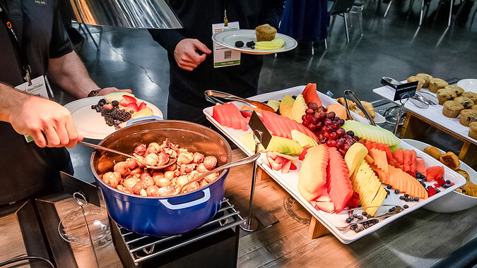 A buffet table with assorted breakfast items.