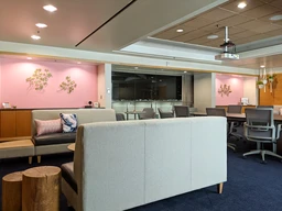 Modern office lounge featuring light gray sofas.