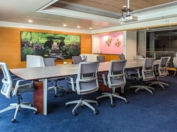 Spacious conference room with a large oval table.
