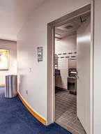 A restroom entrance with a partially opened door.
